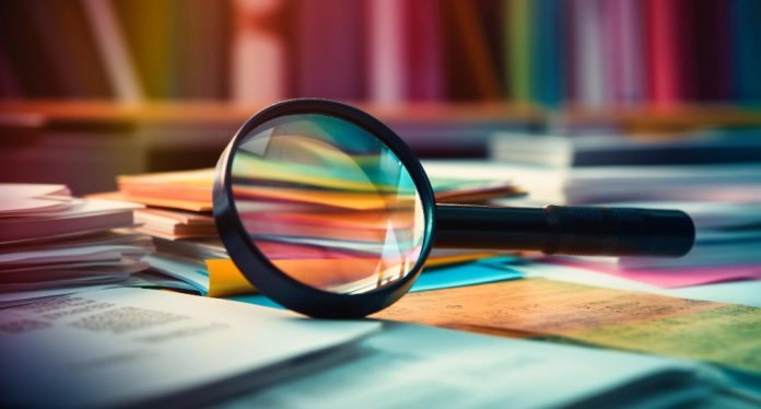magnifying glass on books research